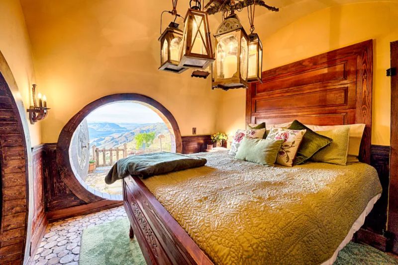 A bedroom with lighting fixtures crafted from wooden pieces