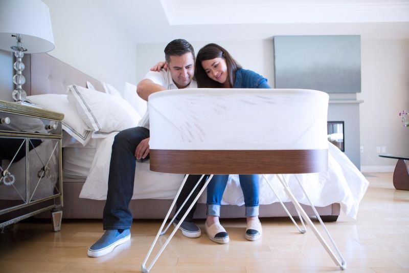 Snoo smart crib plays sounds, rocks firmly to lull infants to sleep