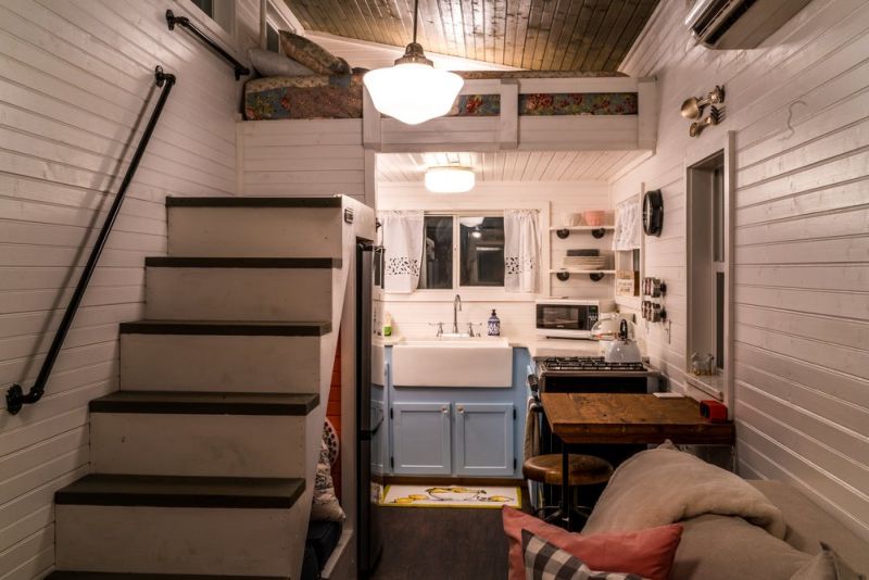 Old Blue Chair Tiny House has cozy reading nook under the staircase