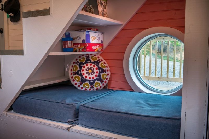 Old Blue Chair Tiny House has cozy reading nook under the staircase