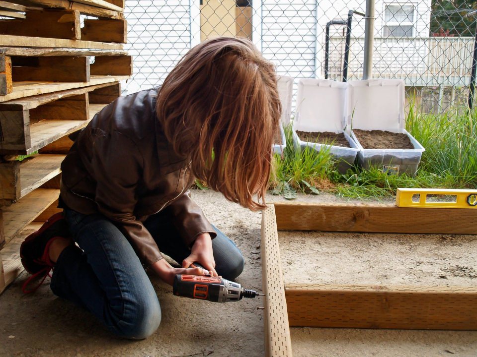 Hailey putting the frame of the mobile shelter home