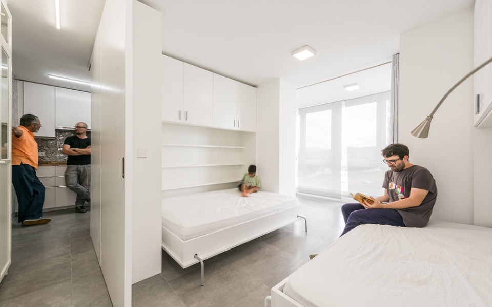 Murphy-styled beds and pullout dividers to create multiple small spaces