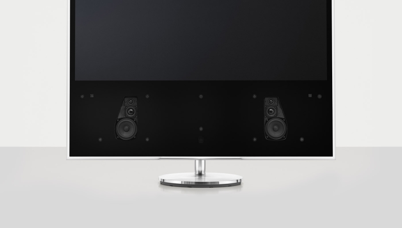 Underneath pleated wooden lamellas this audio system hides