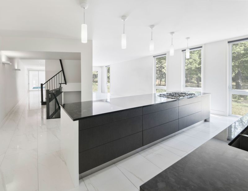 Black cabinetry and staircase to contrast with white