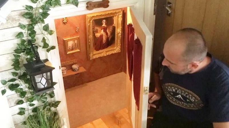 Dog house with portraits of Jessie hung on the walls