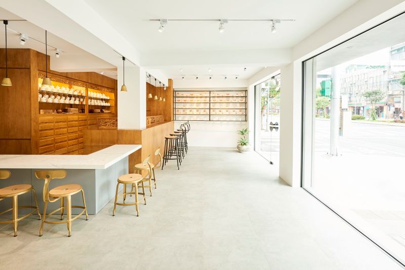 The entrance with floor to ceiling glass doors and windows
