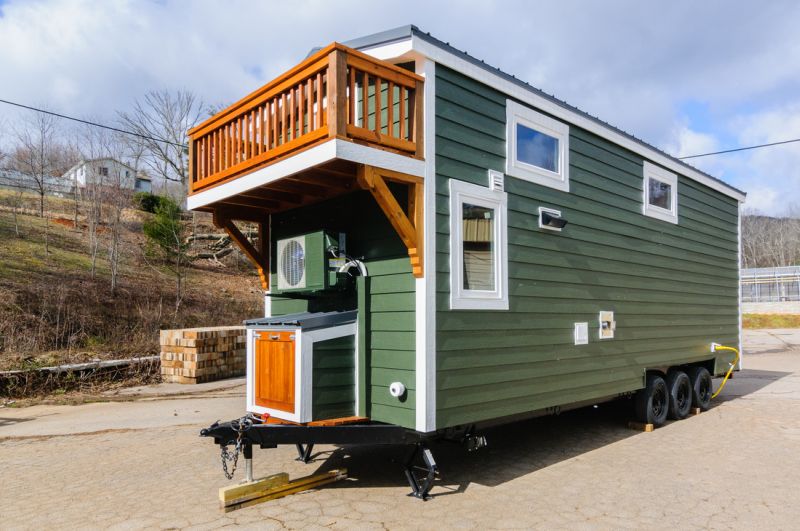 Green wooden sidings with white detailing at exteriors
