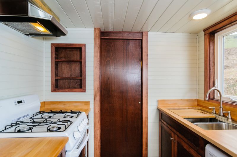 Wooden flooring in kitchen with white ceiling