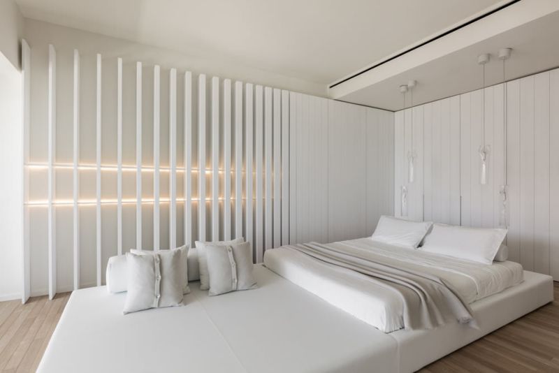 A 4-meter long white leather platform functions as a comfortable bed and a lounge area