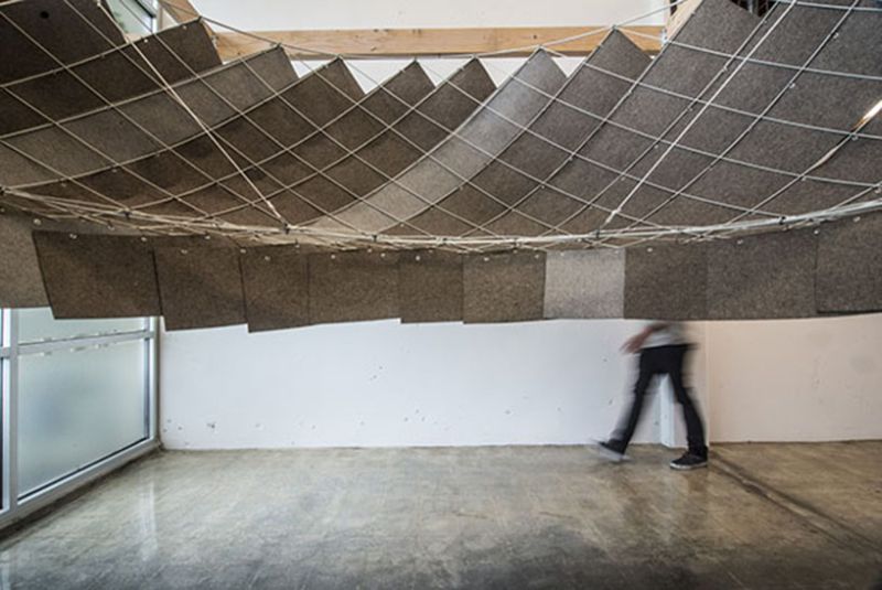 Shrinks to the ceiling to move out of the way when not in use