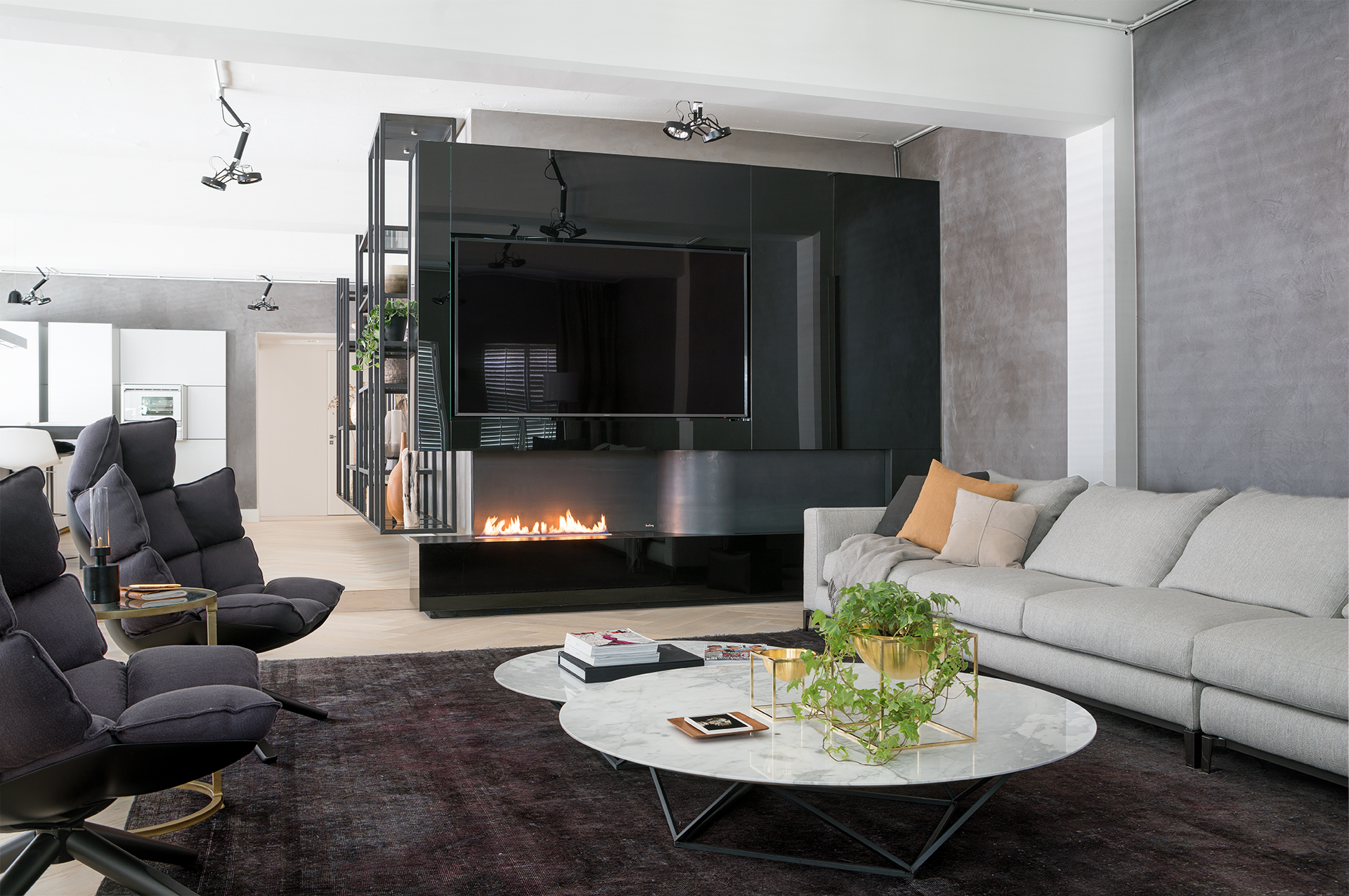 A 80" TV over open fireplace catches eye