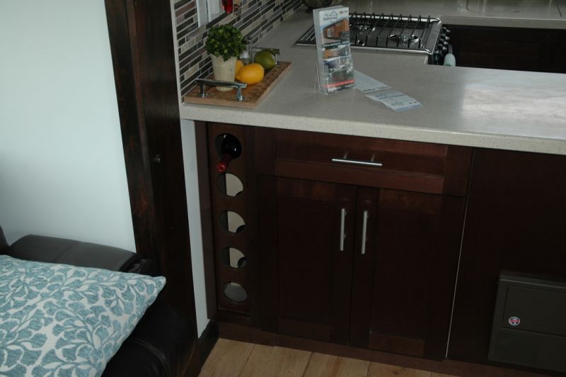 Cabinets and shelving are also designed in dark accent