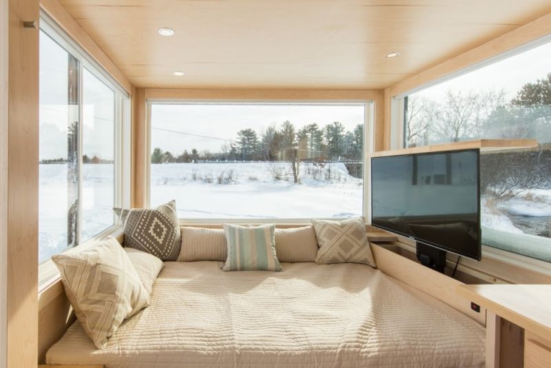 Standard bed against a big glass window