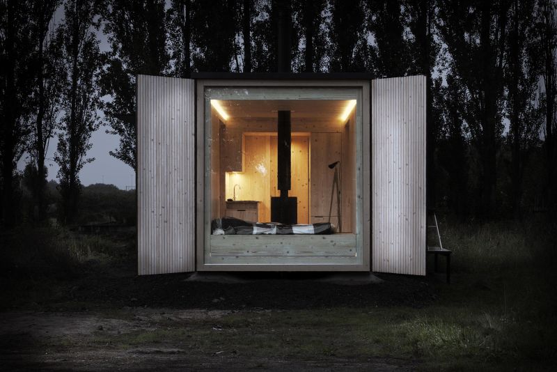 This wooden house has folding sides
