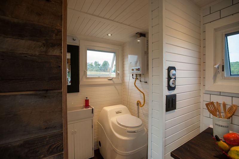 Bathroom with a composting toilet and rain-style shower