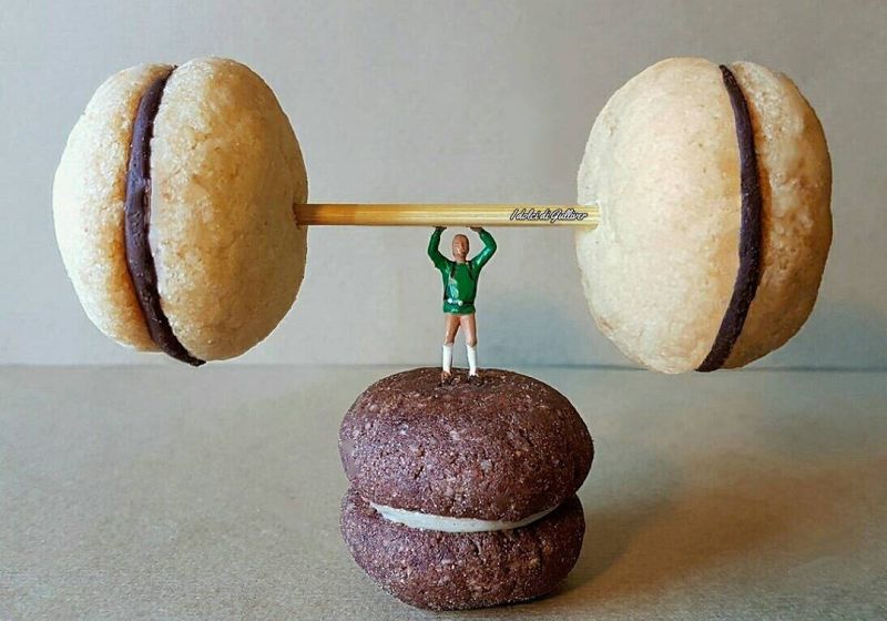 Tiny man weight-lifting