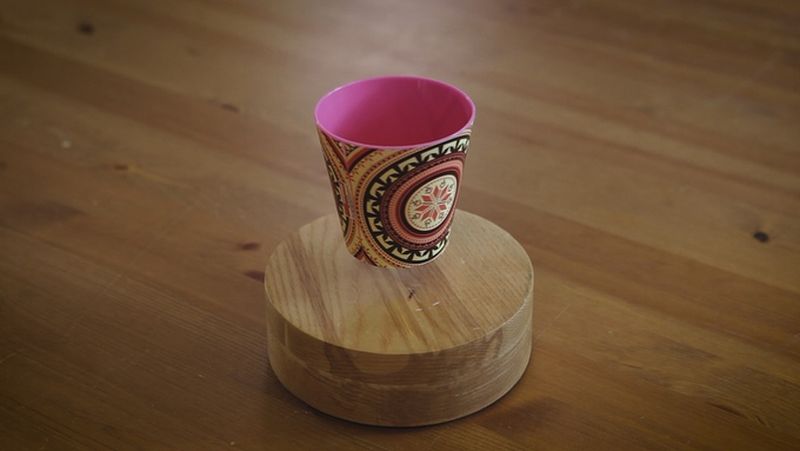 Recycled wood base and levitating magnet