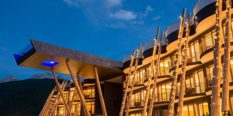Decorative tree trunks create a unique facade