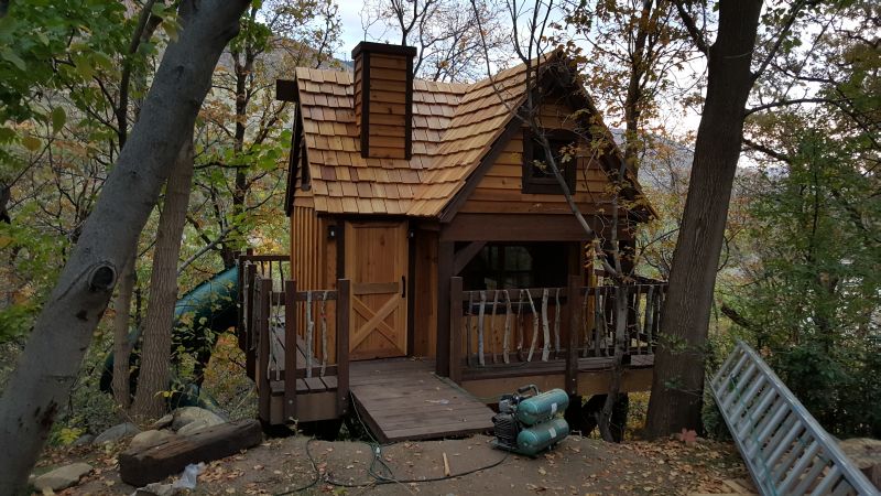 A suspended bridge connecting the yard to the treehouse