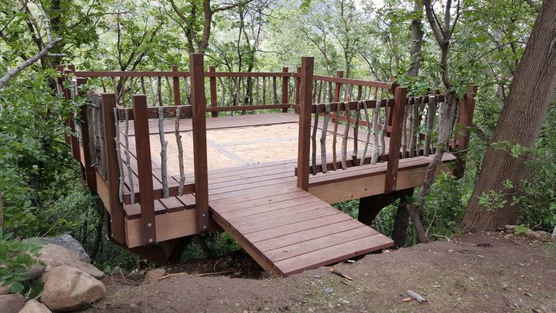 Adding naturalistic railing from wood spindles collected from the site