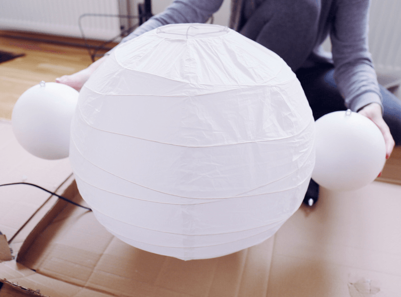Glue both balls on two sides of the lamp