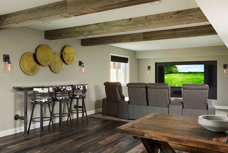 This remodeled basement features home theater and a steampunk bar