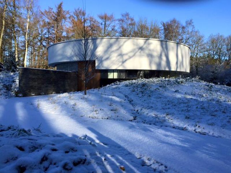 This circular house with big windows brings the outdoors in