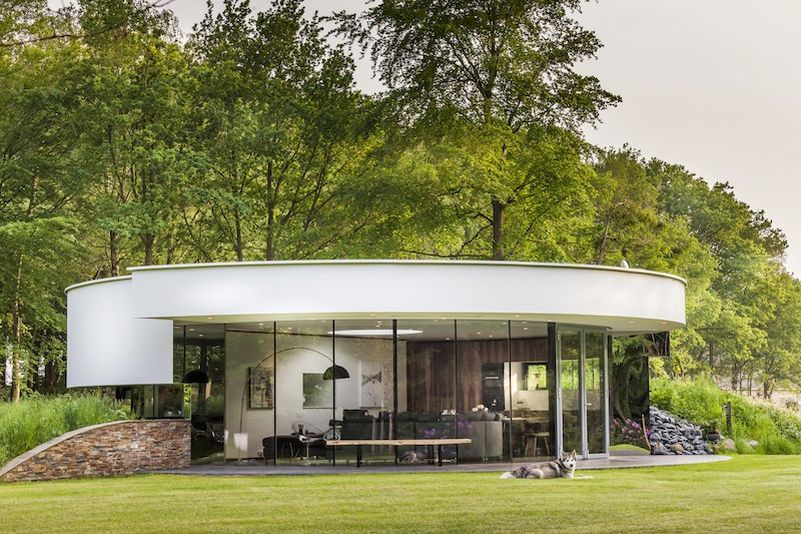This circular house with big windows brings the outdoors in