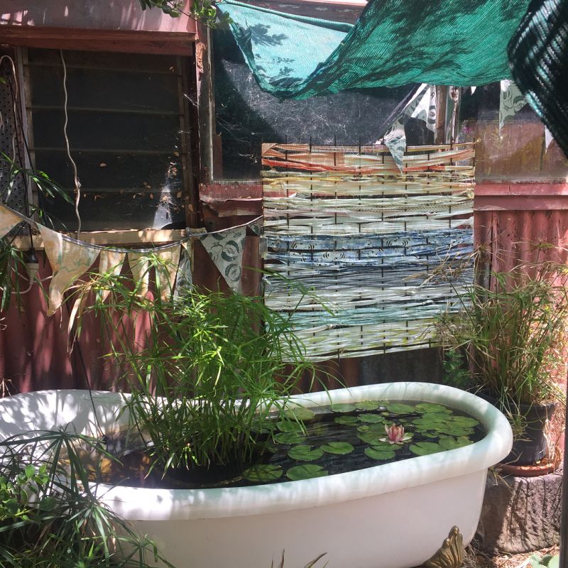 Old bathtub into garden pond