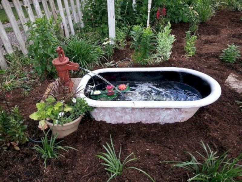 Old bathtub into garden pond