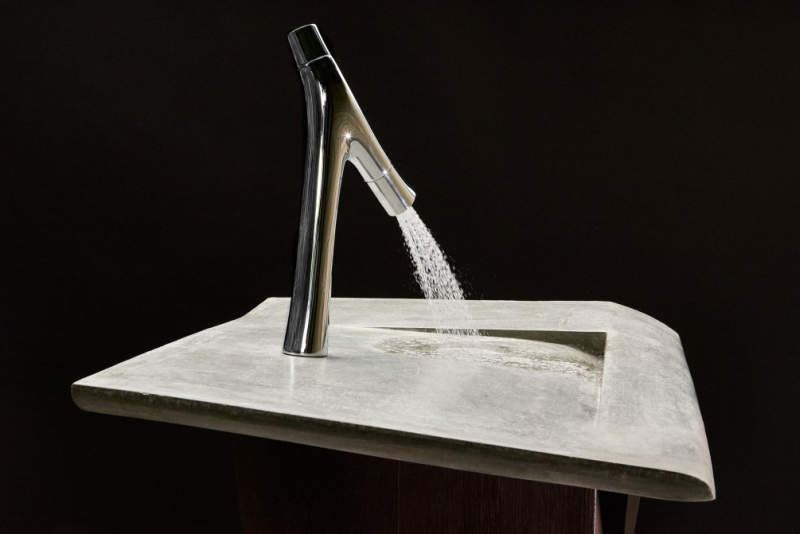 This concrete incline washbasin allows water to drain into the corner