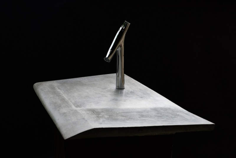 This concrete incline washbasin allows water to drain into the corner