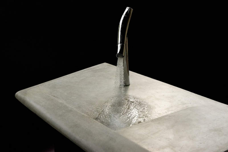 This concrete incline washbasin allows water to drain into the corner