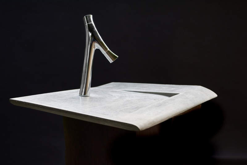 This concrete incline washbasin allows water to drain into the corner