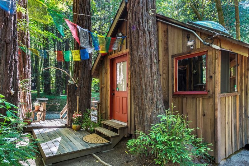 This boho style cabin comes with its own treehouse, zip lines
