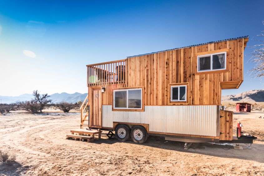 Peacock tiny house on wheels The Peacock tiny house by Rob Millar of Old Hippie Design is a classic mobile home featuring an impressive rooftop balcony accessed via wooden staircase at the back. The interiors are styled in a certain south-western flair while exteriors are finished in wood and corrugated metal siding. 