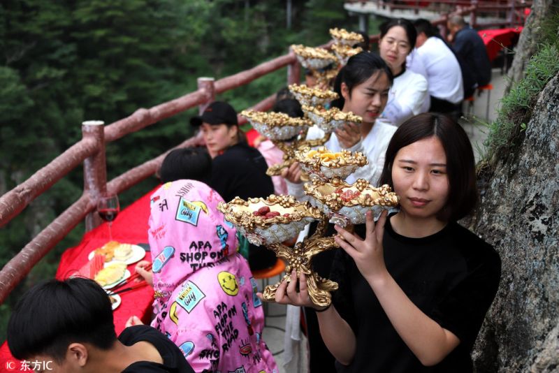 The feast in the sea of clouds on a Narrow Cliffside Pathway in China