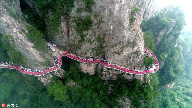 The feast in the sea of clouds on a Narrow Cliffside Pathway in China