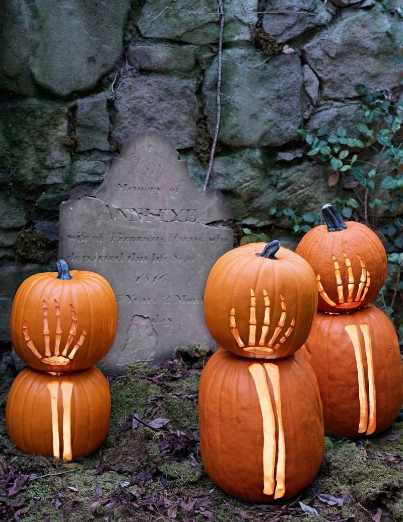 Skull and skeleton-inspired carved pumpkin