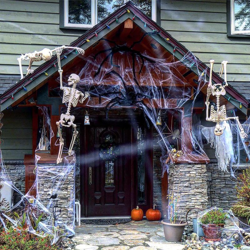 Skeletons climbing up a house