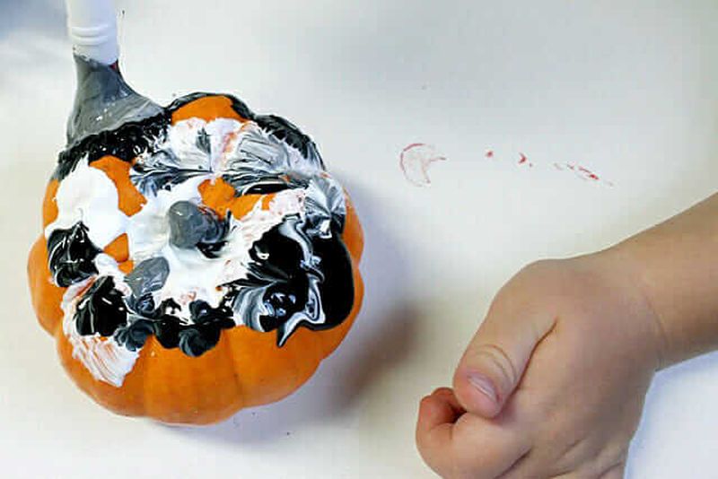 Painting pumpkins Halloween activity for kids 