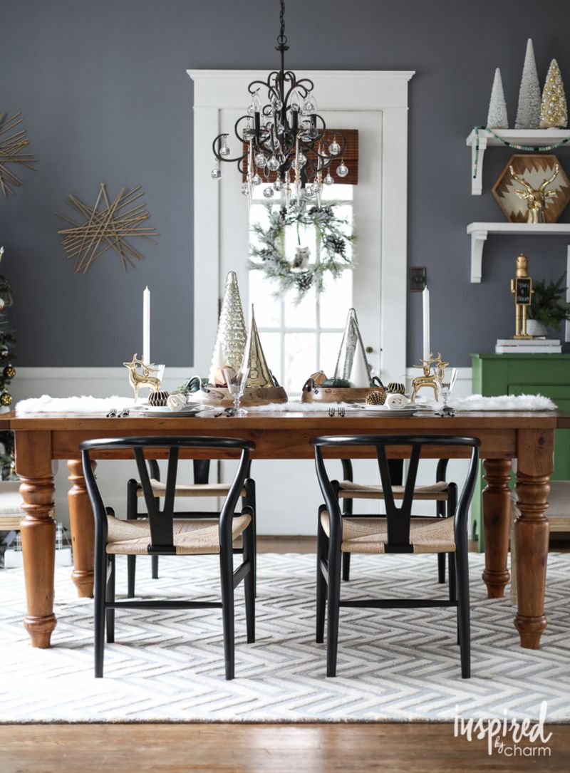 faux fur table runner, black and white dinnerware, and wooden bowls for Christmas table