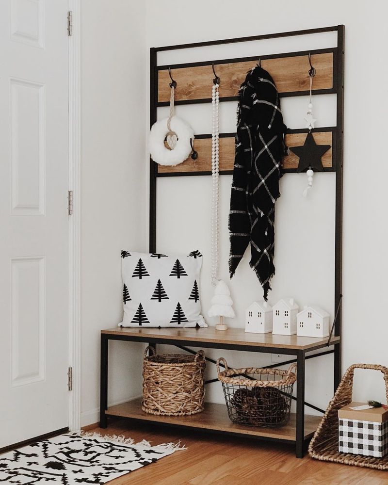 mini houses and rattan baskets in entryway for Christmas 