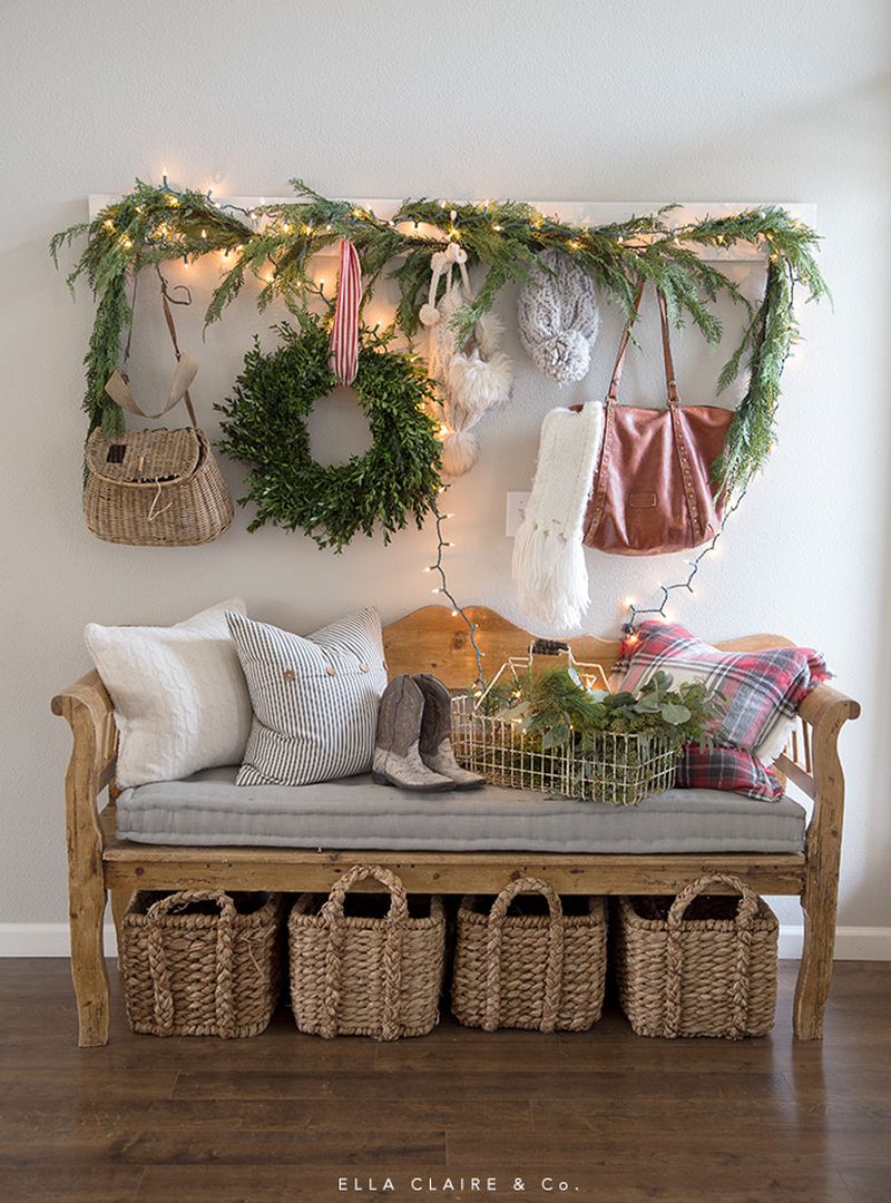 green garland and wreath in entryway for Christmas 