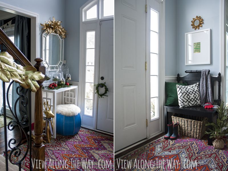 small bench on one side and a console table decorated with greenery on entryway for Christmas 