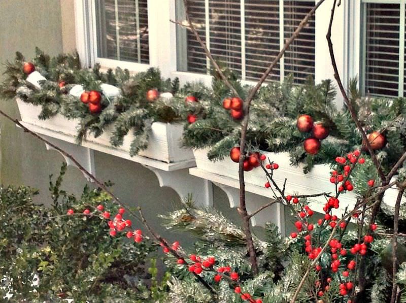 decorate window boxes with red ornaments 