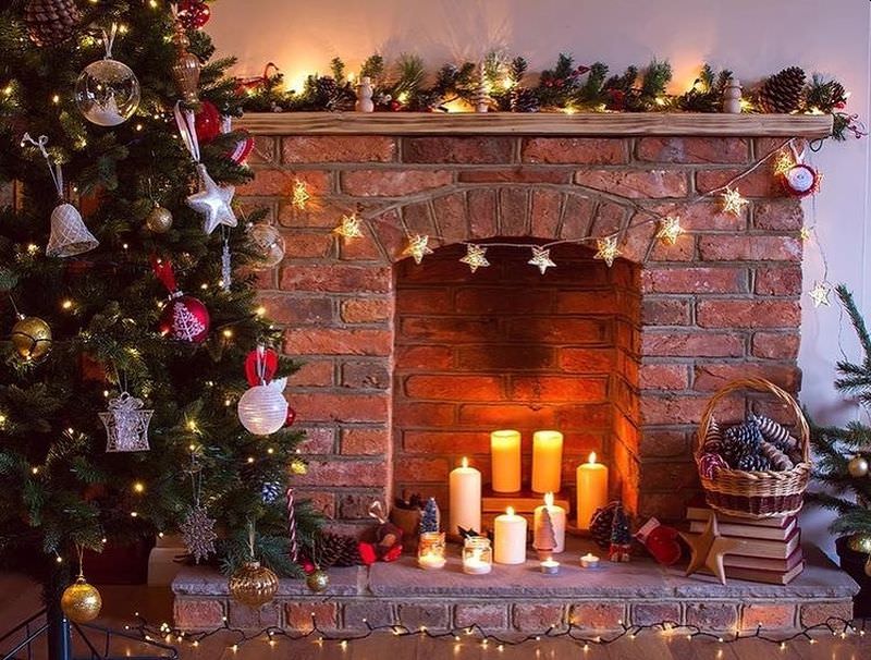 Candles and colorful light strings on fireplace mantel 