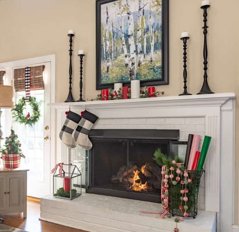 fireplace mantel with tall black candle holders 