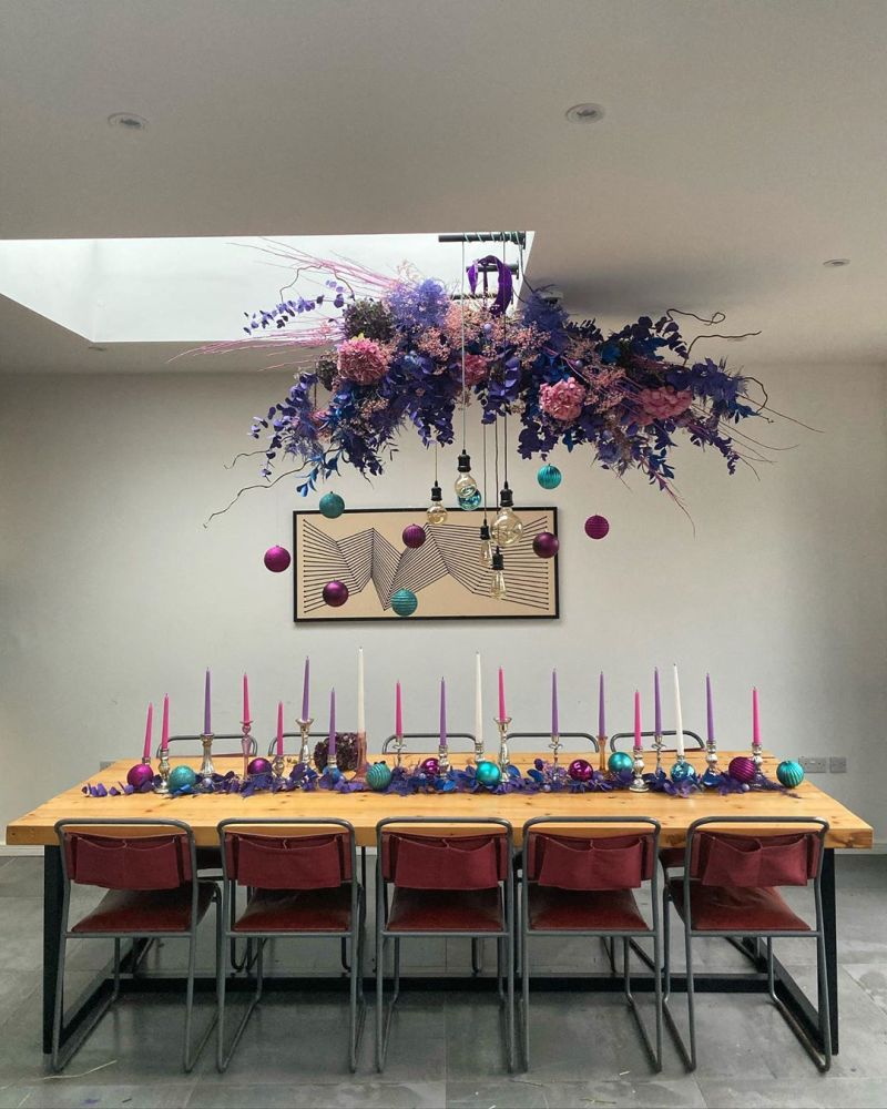 Christmas tablescape with colorful candles and flower chandelier 