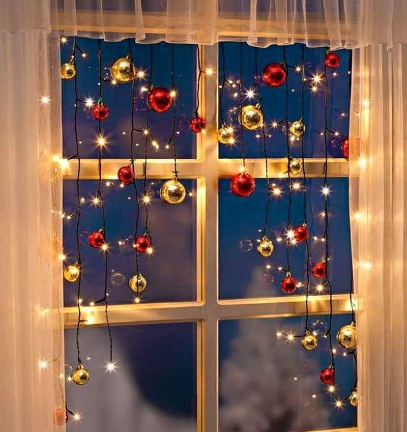 Christmas oraments with lights on window 